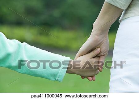 Mother and daughter holding hands, close-up of hands View Large Photo Image Stock Photography - Mother and daughter holding hands, close-up of hands. Fotosearch