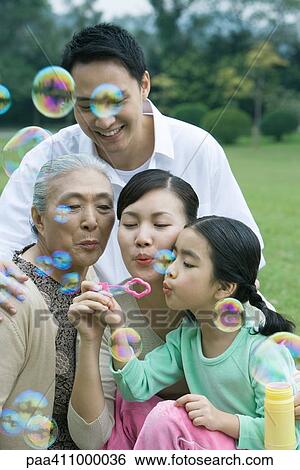 Three generation family blowing bubbles View Large Photo Image Stock Photograph - Three generation family blowing bubbles. Fotosearch