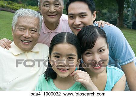 Stock Image - Three generation family in park, portrait. Fotosearch