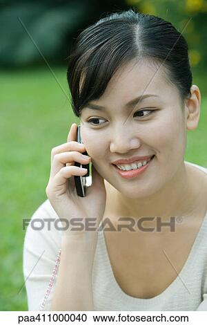 Stock Image - Woman using cell phone, close-up. Fotosearch