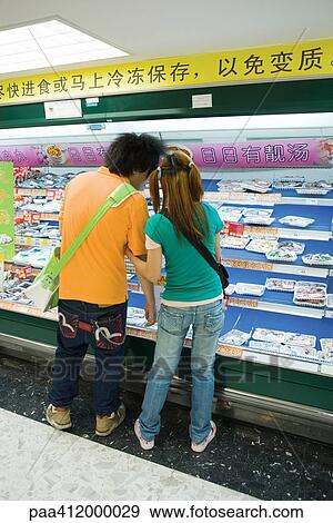 Stock Photo - Couple in supermarket. Fotosearch