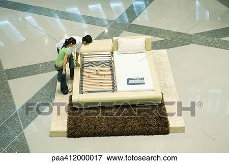 Couple looking at mattress display View Large Photo Image Stock Photo - Couple looking at mattress display. Fotosearch