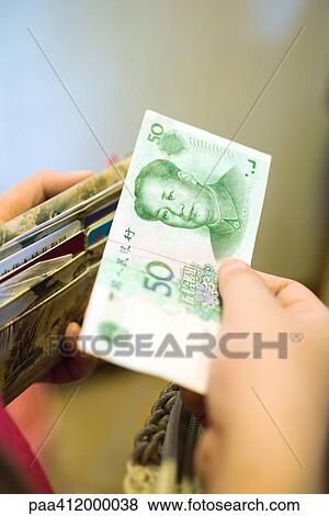 Stock Photo - Hand holding 50 Yuan bill. Fotosearch