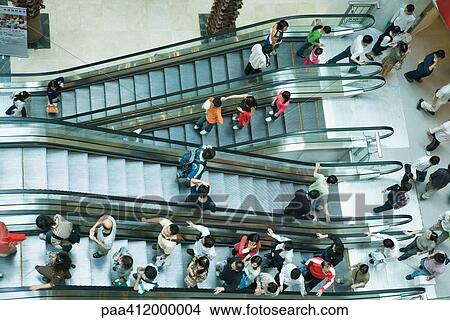 Picture - People taking escalators, high angle view. Fotosearch