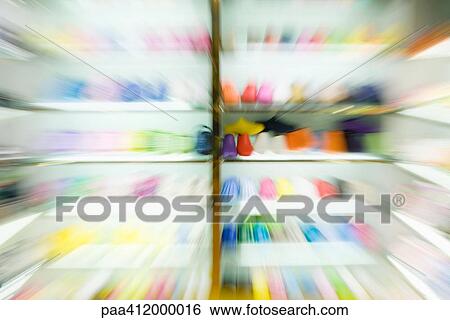 Stock Photograph - Racks of shoes, blurred. Fotosearch