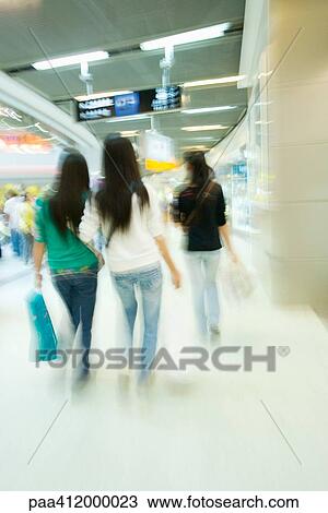 Stock Image - Shoppers in mall, rear view. Fotosearch