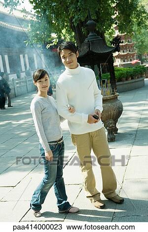 Couple standing near temple, full length, looking at camera View Large Photo Image Stock Image - Couple standing near temple, full length, looking at camera. Fotosearch