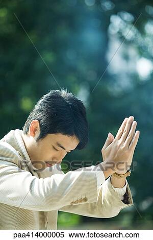 bowing prayer hands holding man head fotosearch