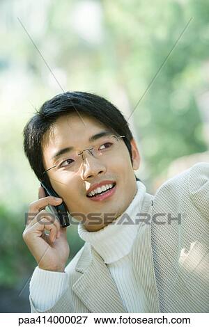Man using cell phone, looking away View Large Photo Image Stock Photo - Man using cell phone, looking away. Fotosearch