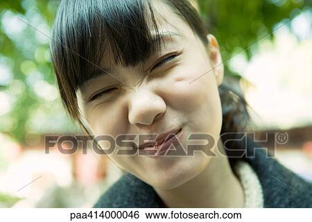 Woman making face, close-up View Large Photo Image Stock Photograph - Woman making face, close-up. Fotosearch