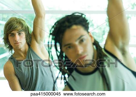 Stock Photography - Exercise class, men with arms raised. Fotosearch