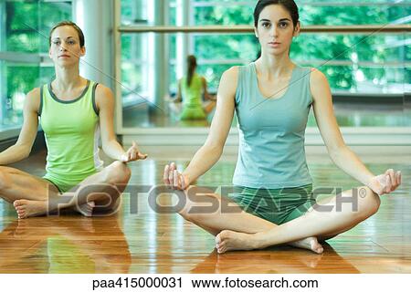 Exercise class, women sitting in lotus position View Large Photo Image Stock Image - Exercise class, women sitting in lotus position. Fotosearch