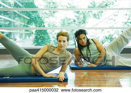 Exercise class, young adults doing leg lifts View Large Photo Image Stock Image - Exercise class, young adults doing leg lifts. Fotosearch