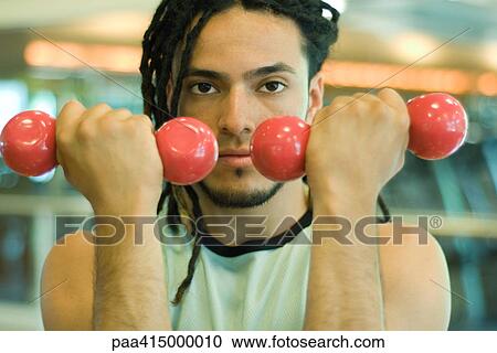 Man holding up dumbbells View Large Photo Image Stock Image - Man holding up dumbbells. Fotosearch