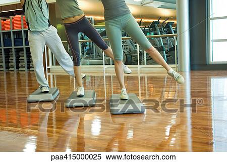 Stock Photography - Step aerobics class, low section. Fotosearch