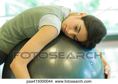 Woman resting on fitness ball View Large Photo Image Picture - Woman resting on fitness ball. Fotosearch