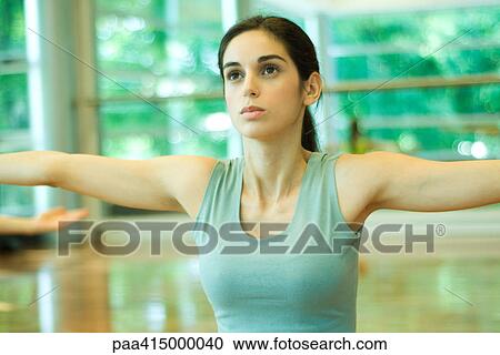 Young woman holding arms out, waist up View Large Photo Image Stock Image - Young woman holding arms out, waist up. Fotosearch