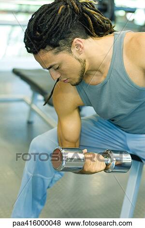 Man working out with dumbbells View Large Photo Image Stock Photo - Man working out with dumbbells. Fotosearch