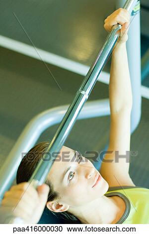 Woman lifting barbell, partial view View Large Photo Image Stock Image - Woman lifting barbell, partial view. Fotosearch