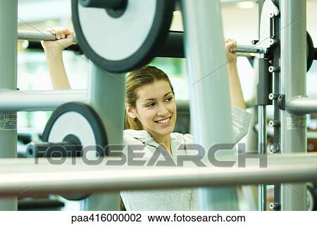 Woman lifting weights View Large Photo Image Stock Image - Woman lifting weights. Fotosearch