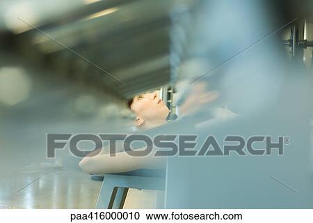 Woman working out with weight machine, blur in foreground View Large Photo Image Stock Image - Woman working out with weight machine, blur in foreground. Fotosearch
