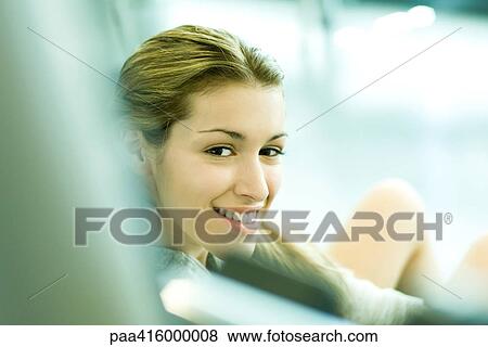 Young woman smiling at camera View Large Photo Image Stock Photo - Young woman smiling at camera. Fotosearch