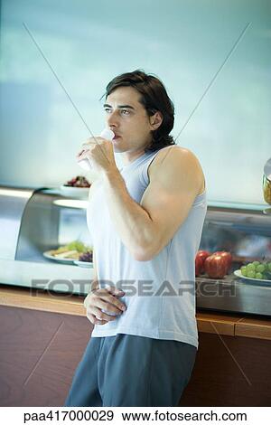 Man having snack in health club cafeteria View Large Photo Image Stock Photo - Man having snack in health club cafeteria. Fotosearch