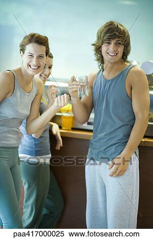 Young adults in exercise clothing, taking break in health club cafeteria View Large Photo Image Stock Photography - Young adults in exercise clothing, taking break in health club cafeteria. Fotosearch