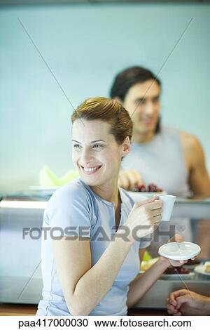 Young woman in exercise clothing, in health club cafeteria View Large Photo Image Stock Image - Young woman in exercise clothing, in health club cafeteria. Fotosearch