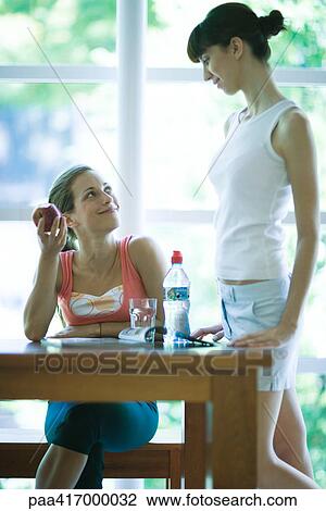 Young women in exercise clothing, chatting in health club cafeteria View Large Photo Image Stock Image - Young women in exercise clothing, chatting in health club cafeteria. Fotosearch