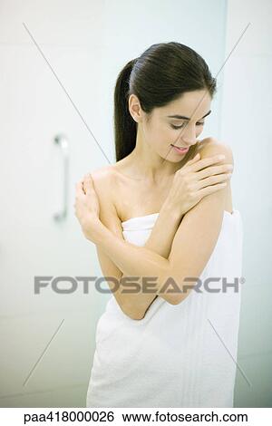 Young woman wrapped in towel, arms crossed and hands on shoulders View Large Photo Image Stock Photograph - Young woman wrapped in towel, arms crossed and hands on shoulders. Fotosearch