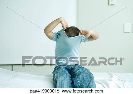 Boy sitting in doctor's office, taking off shirt View Large Photo Image Stock Photography - Boy sitting in doctor's office, taking off shirt. Fotosearch
