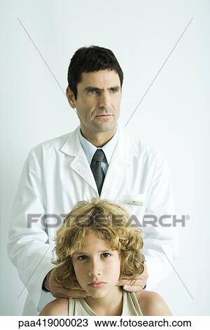 Stock Image - Doctor feeling boy's neck. Fotosearch
