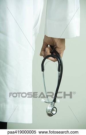 Doctor holding stethoscope, close-up View Large Photo Image Stock Photography - Doctor holding stethoscope, close-up. Fotosearch