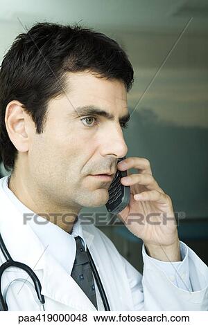 Doctor making phone call View Large Photo Image Stock Photo - Doctor making phone call. Fotosearch