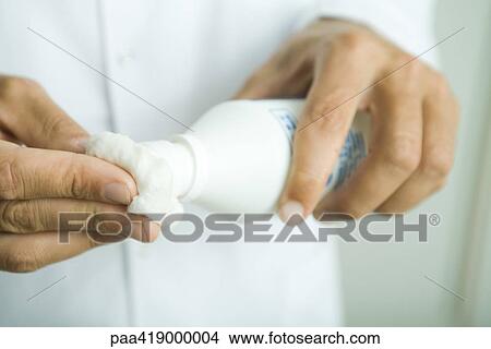 Doctor putting antiseptic on cotton ball, close-up of hands View Large Photo Image Picture - Doctor putting antiseptic on cotton ball, close-up of hands. Fotosearch