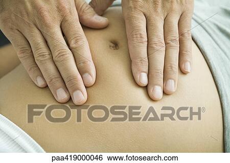 Man's hands on pregnant woman's stomach, close-up View Large Photo Image Stock Photograph - Man's hands on pregnant woman's stomach, close-up. Fotosearch