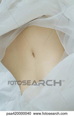 Woman's abdomen, surrounded by sheer fabric, full frame View Large Photo Image Stock Image - Woman's abdomen, surrounded by sheer fabric, full frame. Fotosearch