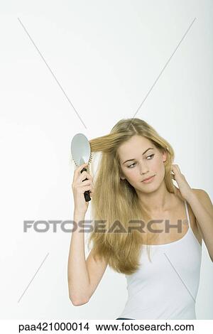 Teenage girl brushing hair View Large Photo Image Picture - Teenage girl brushing hair. Fotosearch