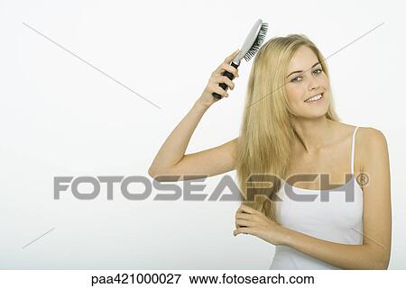 Teenage girl brushing hair View Large Photo Image Stock Photo - Teenage girl brushing hair. Fotosearch