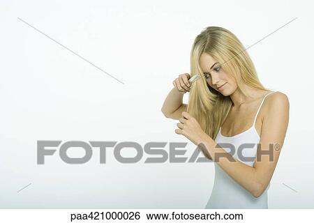 Teenage girl combing hair View Large Photo Image Stock Photograph - Teenage girl combing hair. Fotosearch