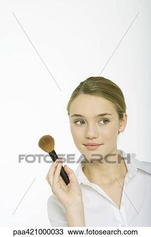 Teenage girl holding blush brush View Large Photo Image Stock Image - Teenage girl holding blush brush. Fotosearch
