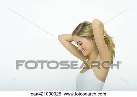 Teenage girl holding hair back, side view View Large Photo Image Stock Photography - Teenage girl holding hair back, side view. Fotosearch