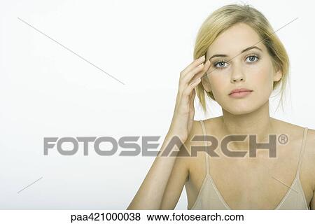 Teenage girl wearing make-up, touching side of eye View Large Photo Image Stock Photo - Teenage girl wearing make-up, touching side of eye. Fotosearch