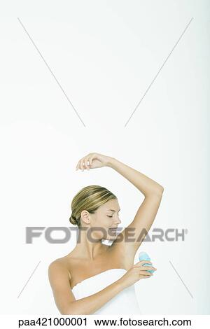 Young woman applying deodorant View Large Photo Image Stock Image - Young woman applying deodorant. Fotosearch