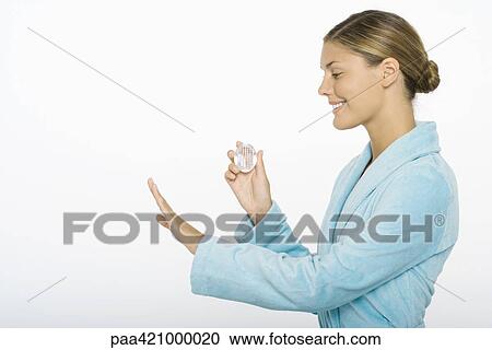 Young woman holding nail brush, admiring fingernails View Large Photo Image Stock Image - Young woman holding nail brush, admiring fingernails. Fotosearch