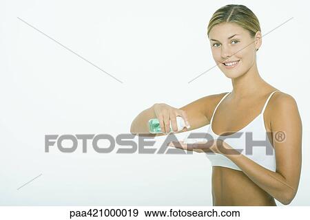 Young woman squeezing beauty product into hand View Large Photo Image Stock Photo - Young woman squeezing beauty product into hand. Fotosearch