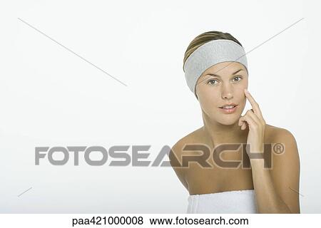 Young woman touching cheek View Large Photo Image Stock Photo - Young woman touching cheek. Fotosearch