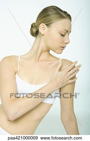 Stock Photo - Young woman touching shoulder. Fotosearch