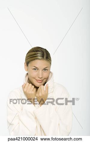 Young woman wearing bathrobe, holding onto collar View Large Photo Image Picture - Young woman wearing bathrobe, holding onto collar. Fotosearch